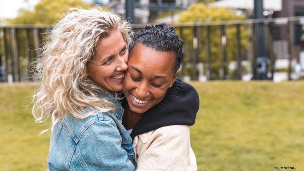 A mixed race lesbian couple embrace in London