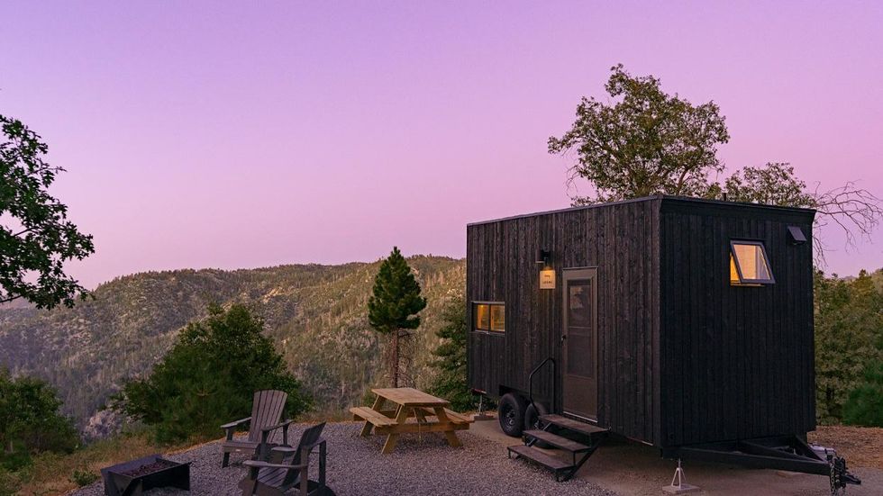 A tiny house cabin overlooking a forest in California