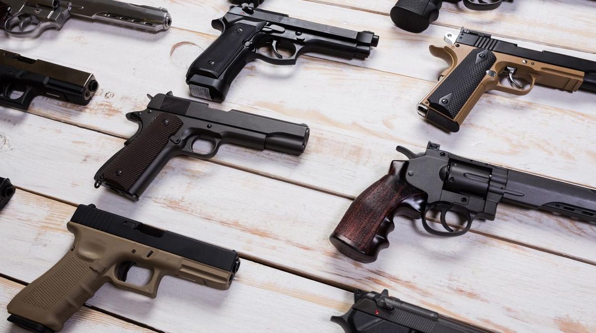 a variety of handguns displayed 