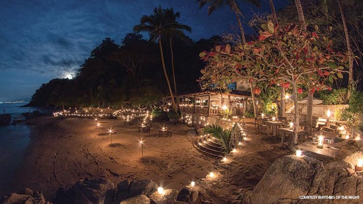 A view of huts from across a lagoon