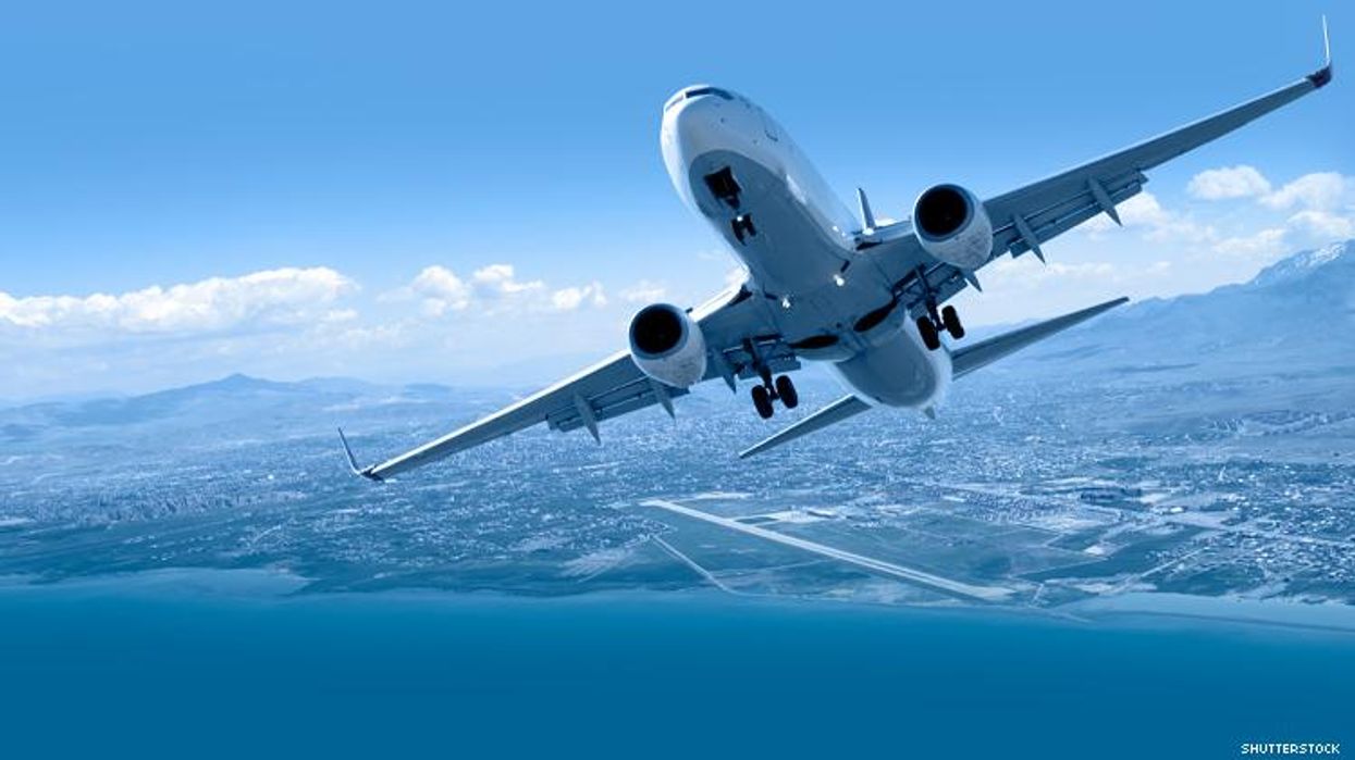 airplane taking off over mountains and ocean