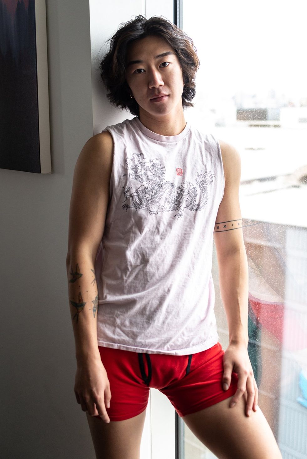 Asian American in sleeveless shirt and red boxer briefs