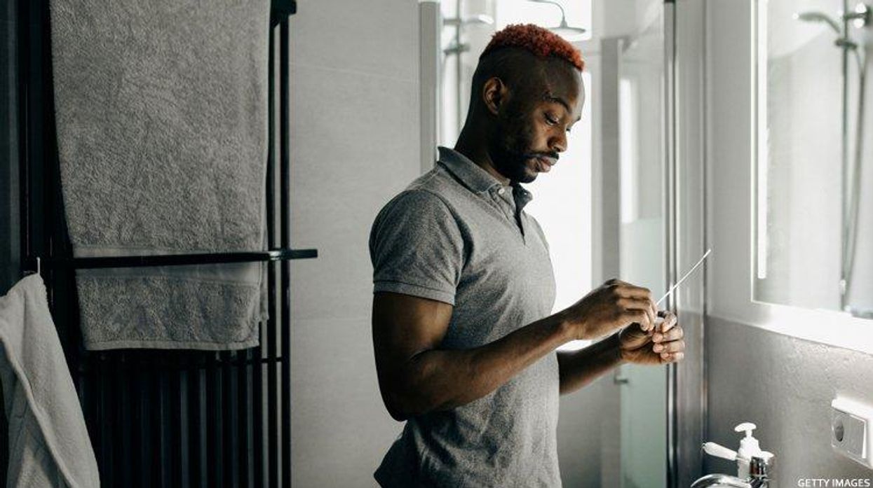 Black man takes a home COVID test