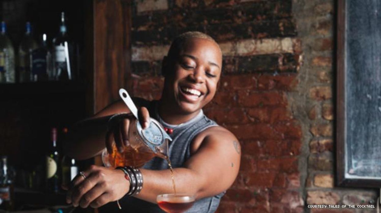 Black mixologist Tiffanie Barriere pours a cocktail