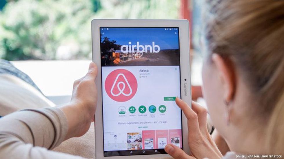 Blond woman looking at Airbnb site
