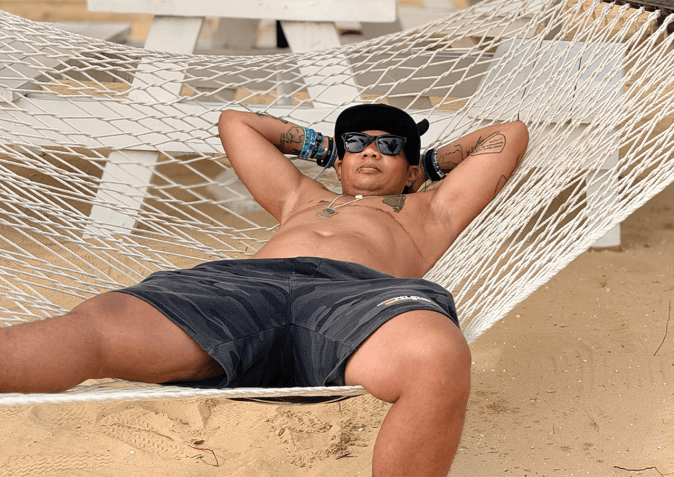 Chelle relaxes on a hammok on the beach
