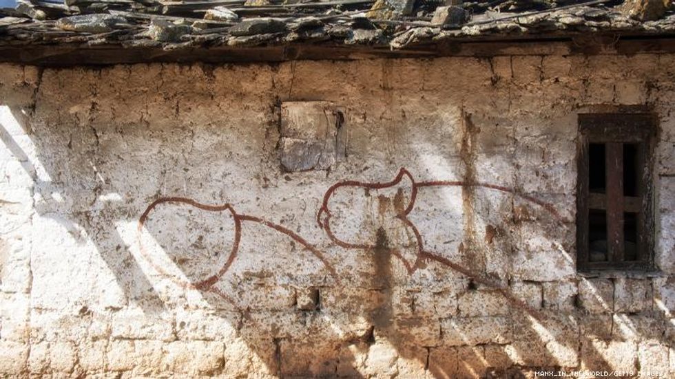 Esoteric Symbol penises on a wall in Bhutan