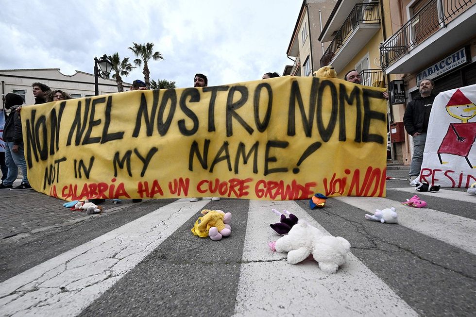 Families of dead migrants protest mass burials in Italy.