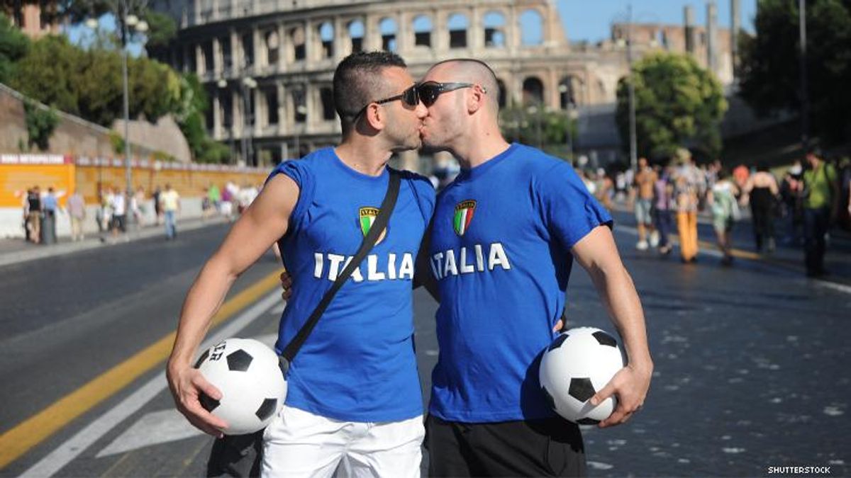 Gay soccer fans kiss in front of Rome colosseum