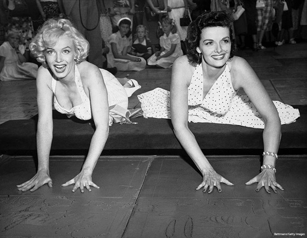Glamour queens Marilyn Monroe and Jane Russell, making their imprint on the walk of fame in front of the Chinese Theatre, after working together in Gentlemen Prefer Blondes