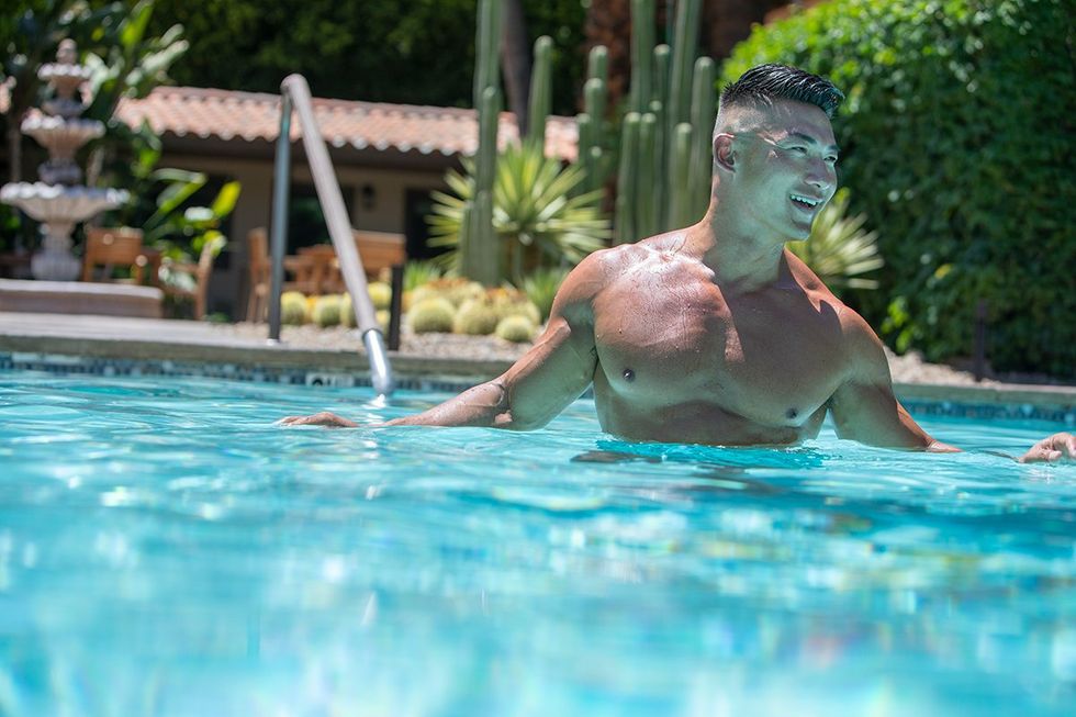 Hunky gay man in the pool at the Santiago Resort, a gay men's clothing optional resort