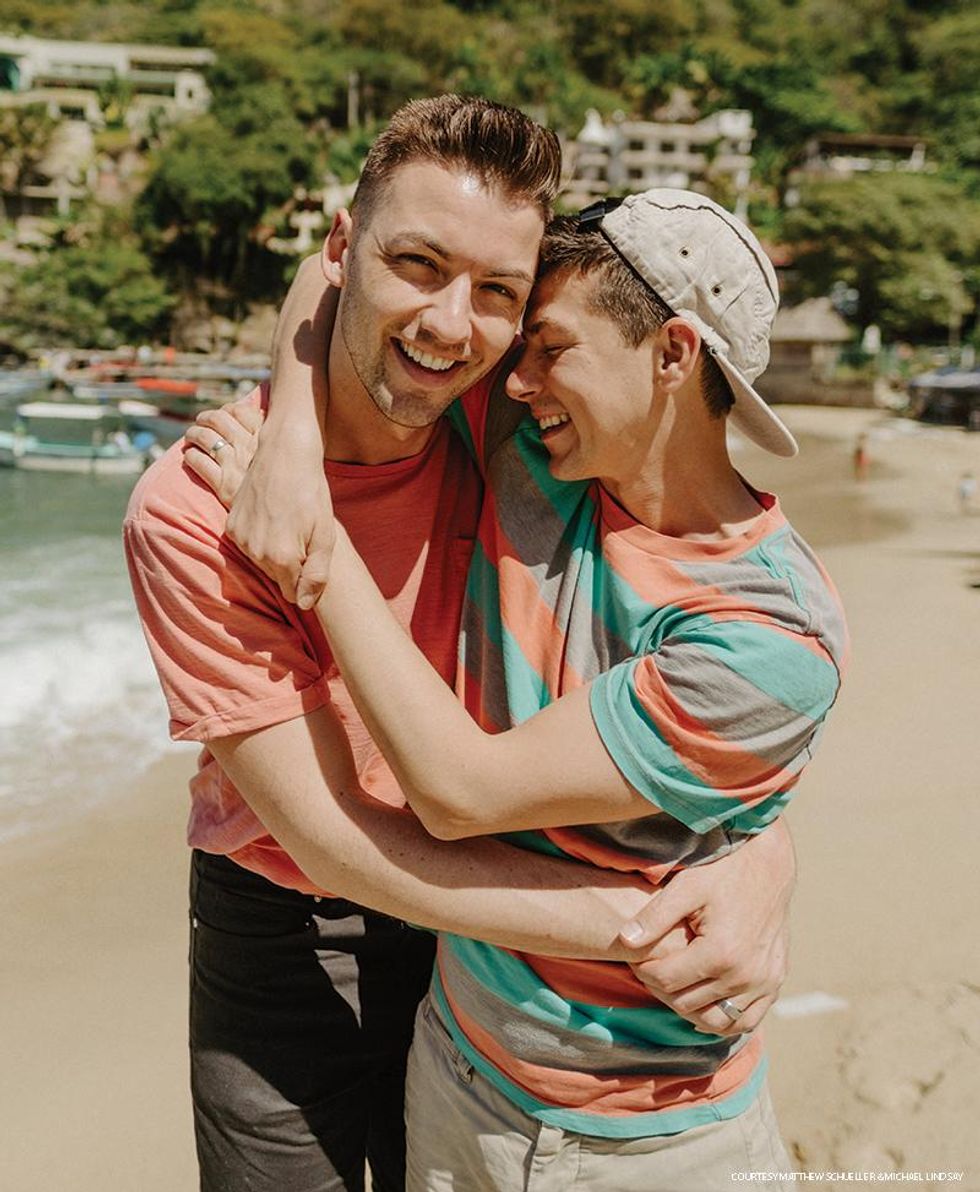 Husbands Matthew Schueller and Michael Lindsay share a playful embrace