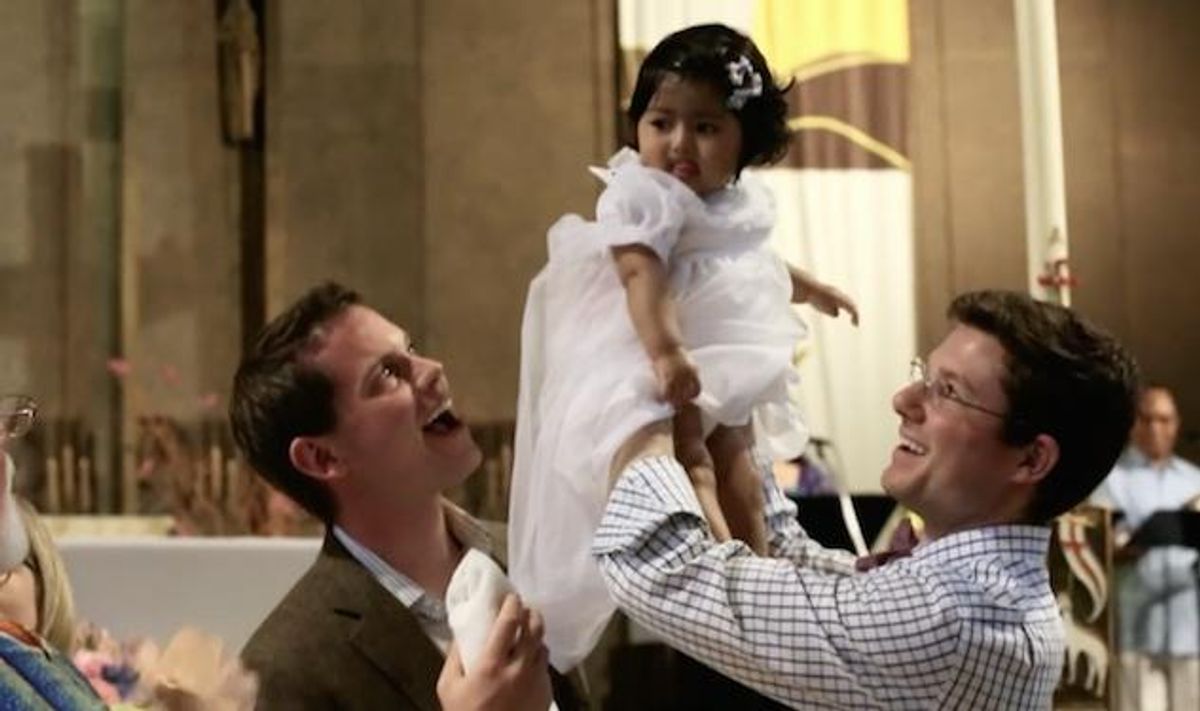 WATCH: Gay Catholic Dads Baptize Their Daughter 