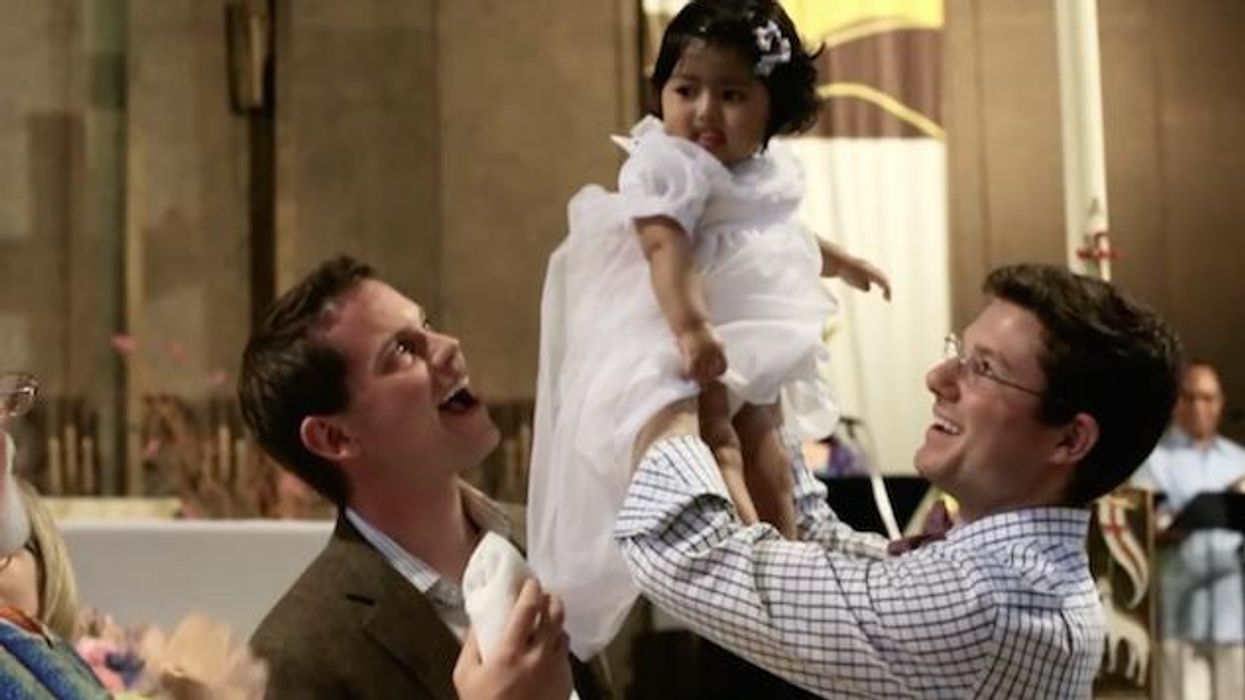 WATCH: Gay Catholic Dads Baptize Their Daughter