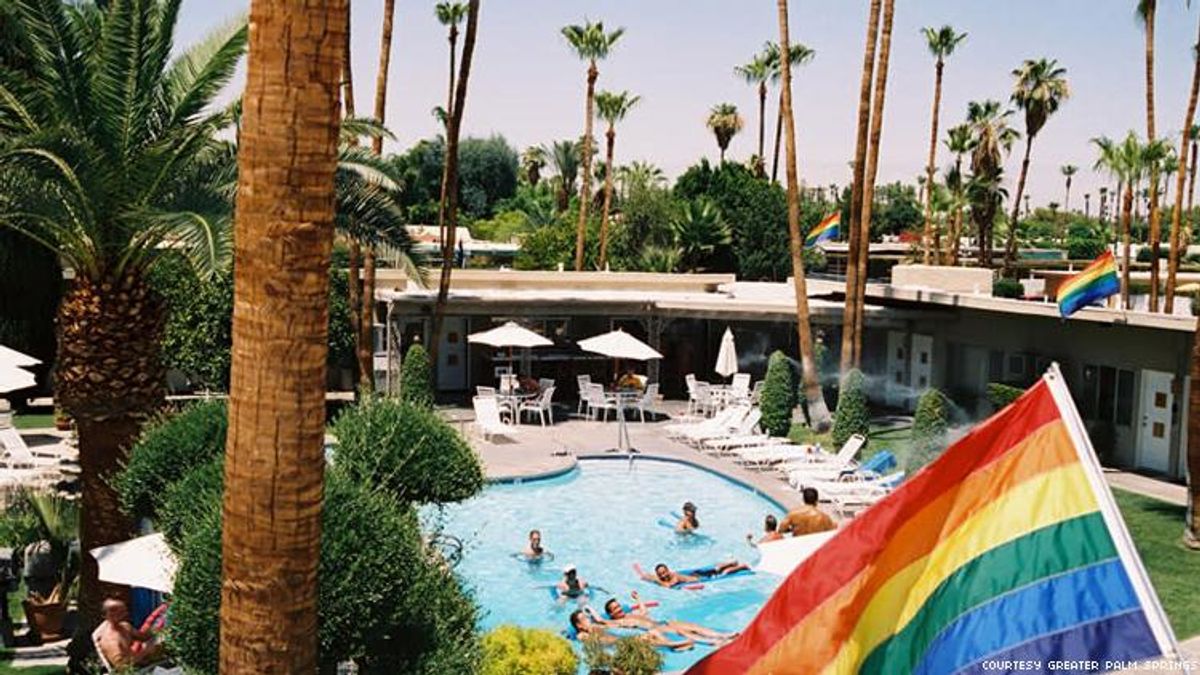 INNdulge pool with rainbow flag gay hotel in Palm Springs