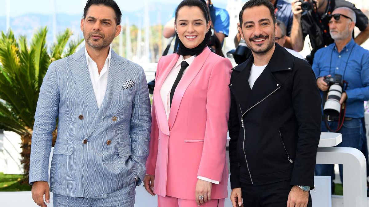 Iranian actress Taraneh Alidoosti center in pink suit with costars from Leila's Brothers