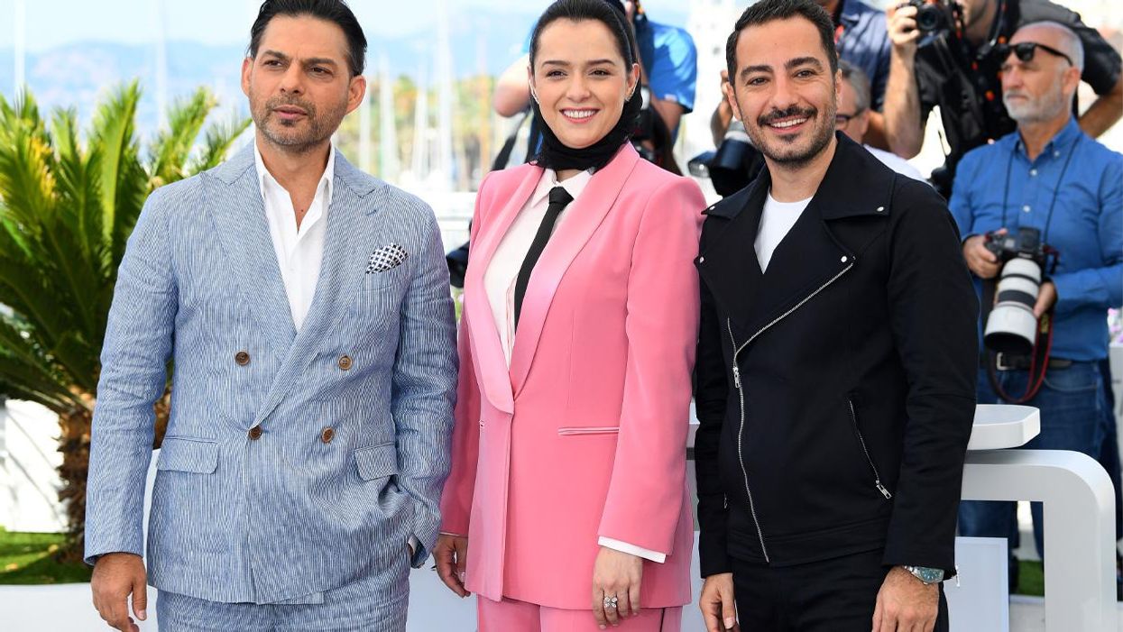 Iranian actress Taraneh Alidoosti center in pink suit with costars from Leila's Brothers