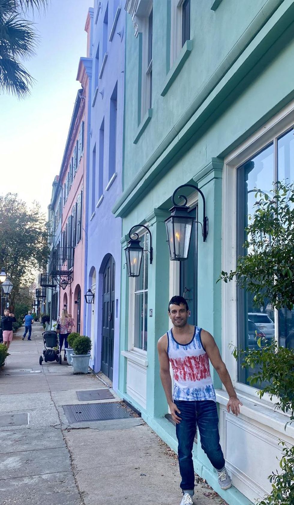 Joey Amato in front of colorful row houses in Charleston SC