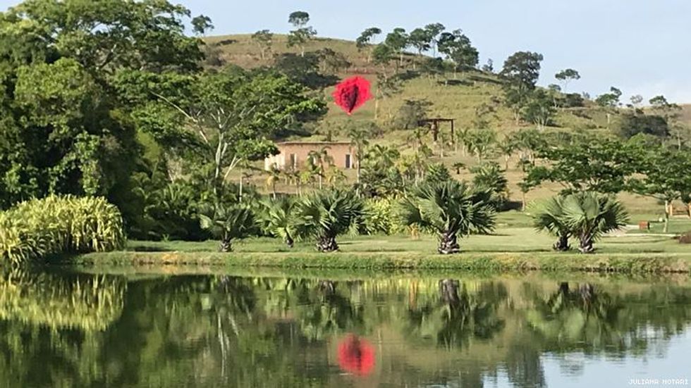 Juliana Notari resin artwork Diva on Brazil hillside reflected in lake