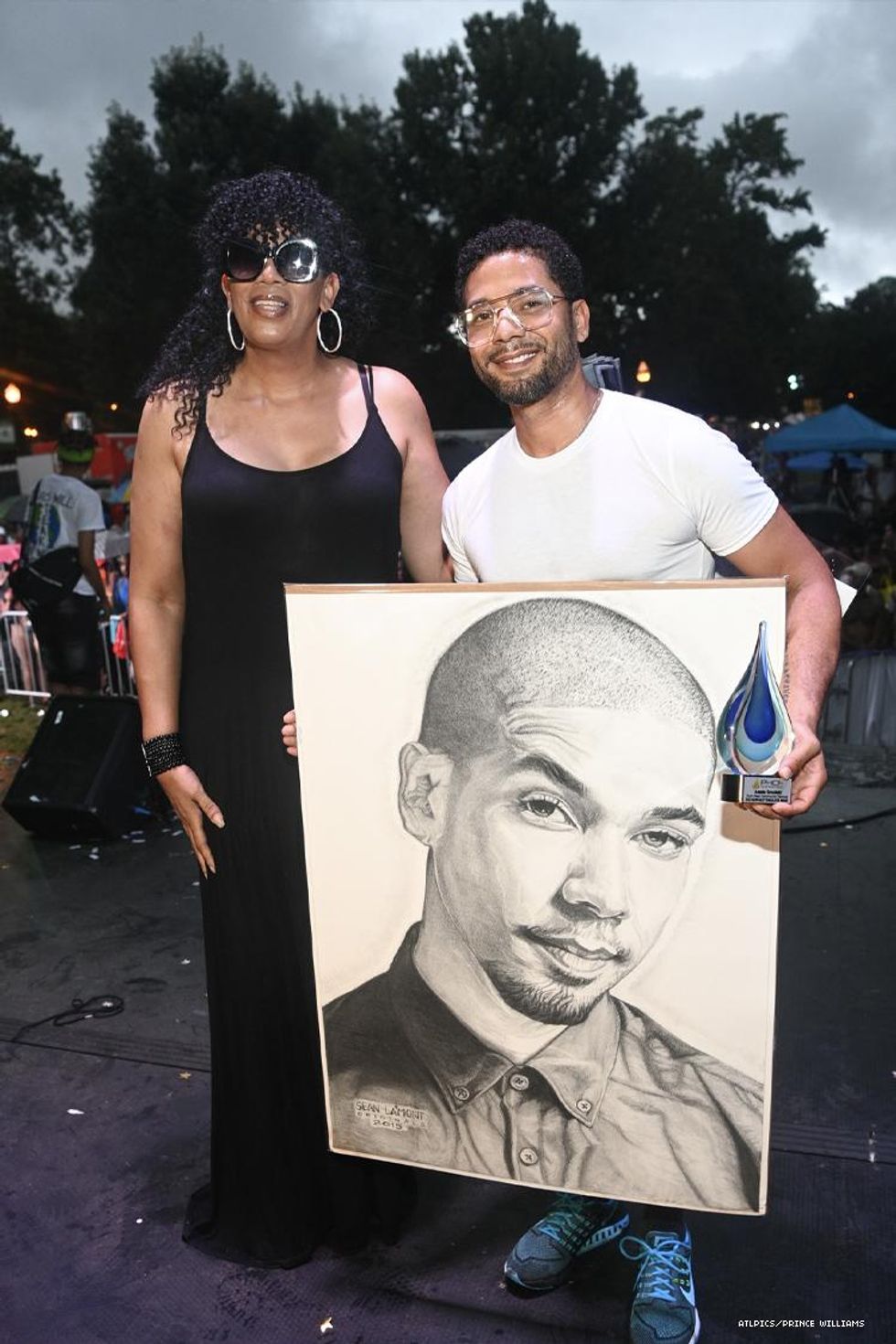 Jussie Smollett with a portrait of him
