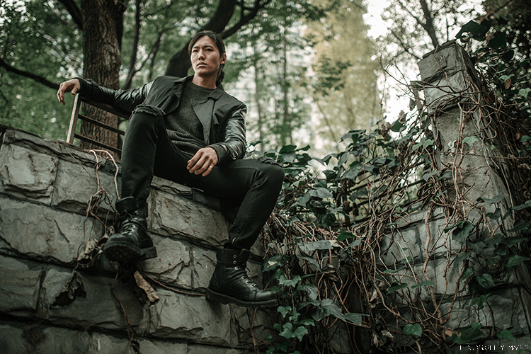 Man in China sits on a wall
