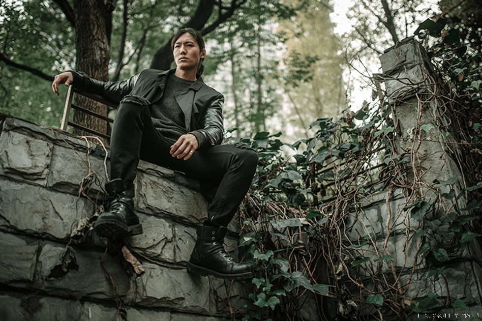 Man in China sits on a wall