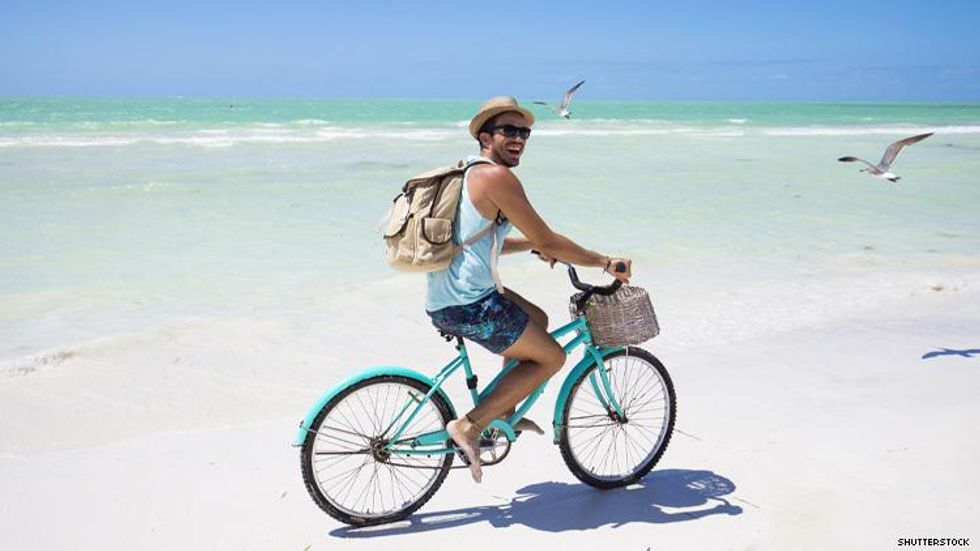Man on a bicycle on a beach in Mexico