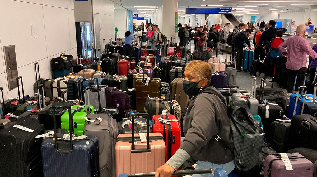 Man stands with dozens of suitcases in LA during Southwest flight cancelations