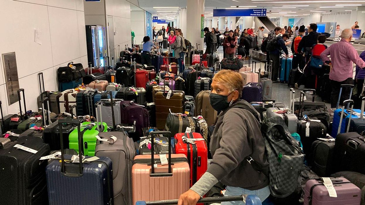 Man stands with dozens of suitcases in LA during Southwest flight cancelations