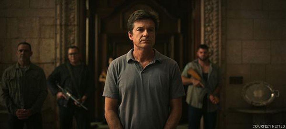 Marty Byrde (Jason Bateman) stands flanked by armed guards at the home of drug lord Omar Navarro on Ozark.