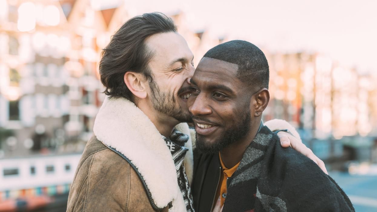 mixed race gay couple near a canal in Amsterdam
