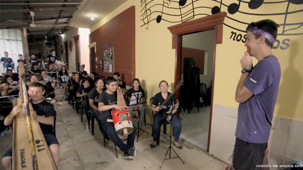 On Amazing Race James with the children orchestra