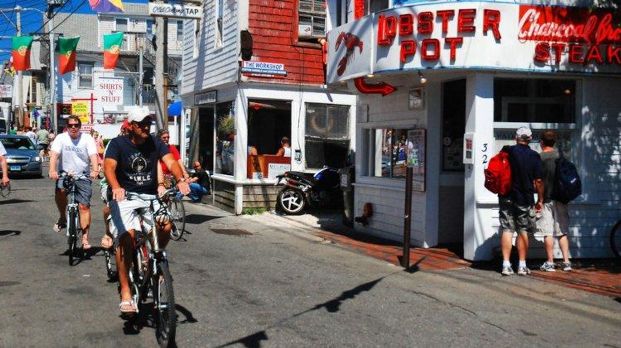 P-town commercial street with two male bike riders