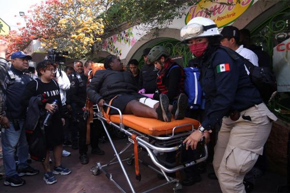 Paramedic tend to woman injured in Mexico subway collision