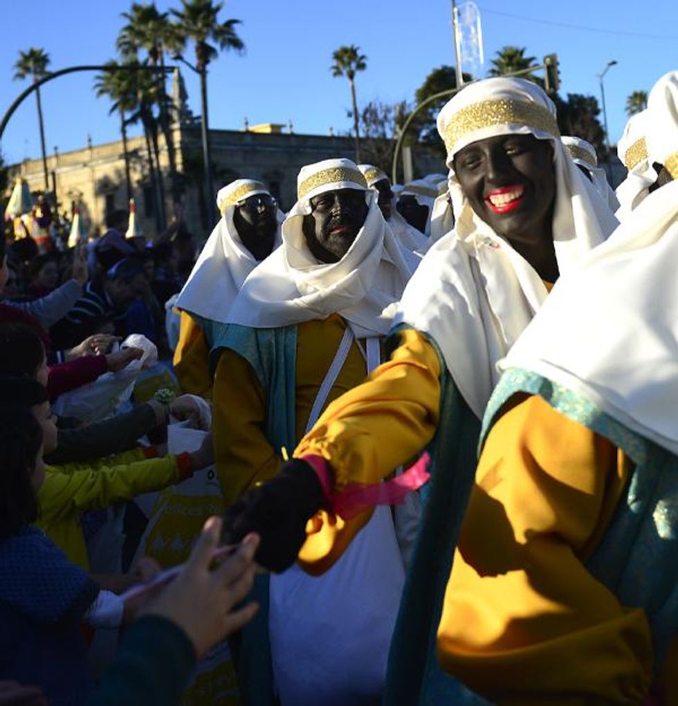 People dressed in blackface at Spain Three Kings Parade