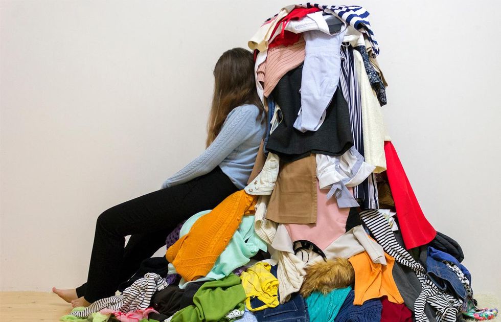 person on pile of clothes