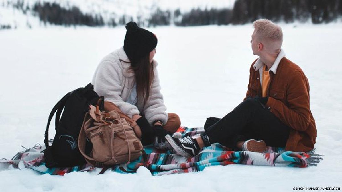 Photo of Couple Picnicing in Snow