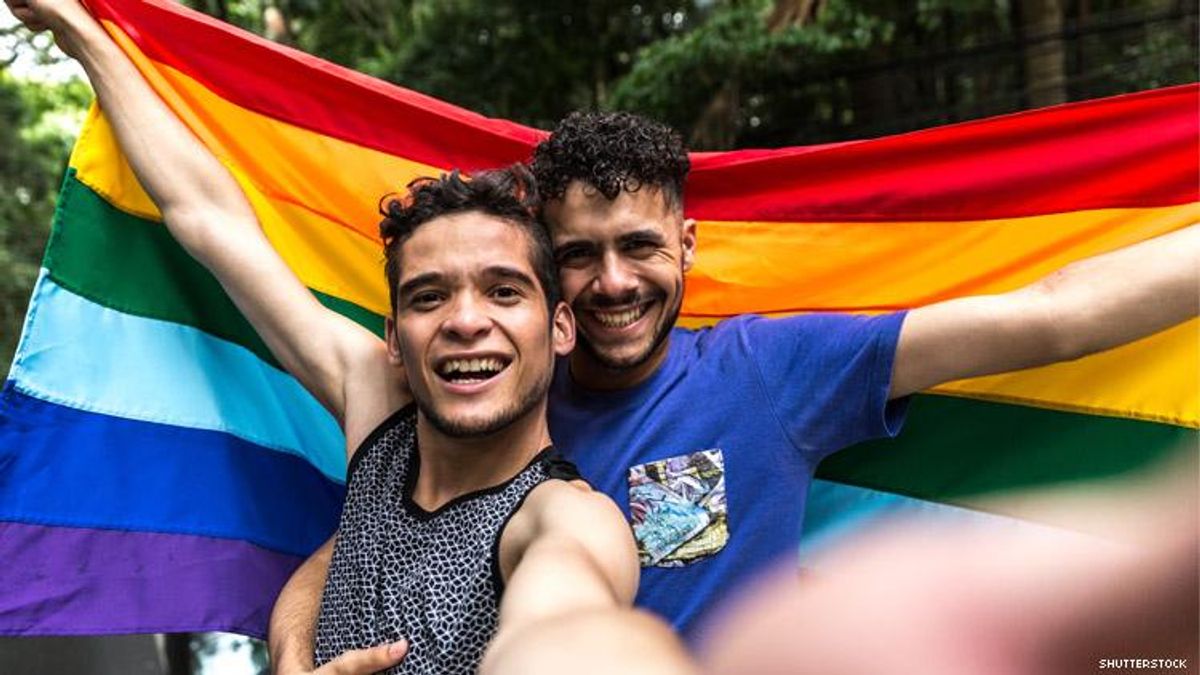 Queer couple with a rainbow flag