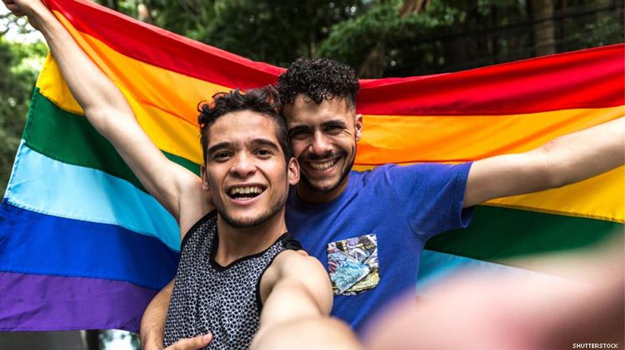 Queer couple with a rainbow flag