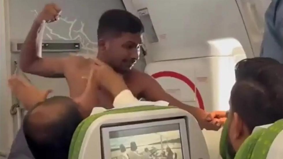 Shirtless man punches fellow passenger