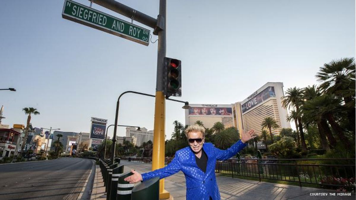 Siegfried stands below the newly named Siegfried & Roy Drive sign