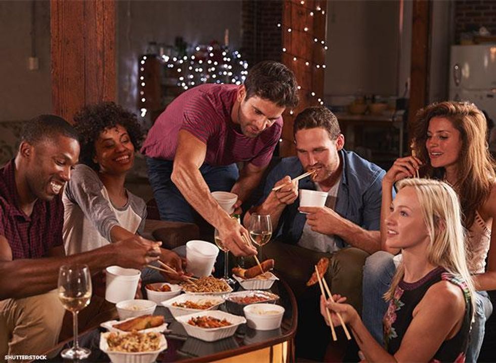 six people around a table with Chinese take-out