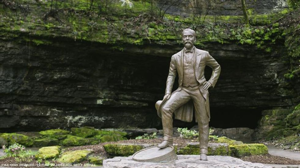 Statue of Jack Daniel in front of Cave
