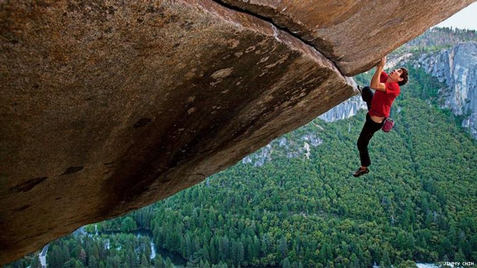Still from doc Free Solo in which a man free climbs El Capital high above forest