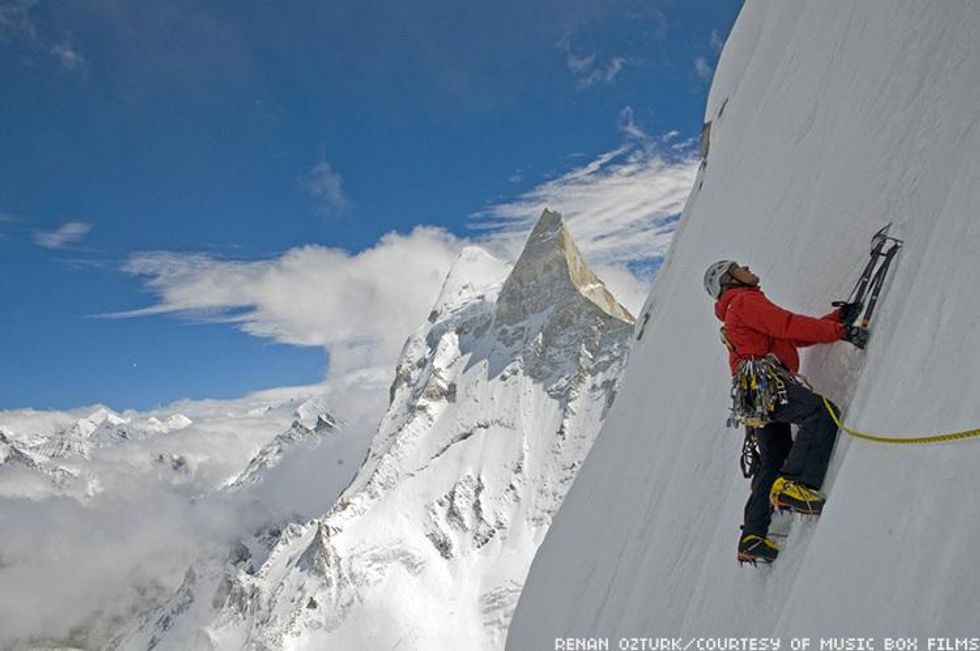 Still from film Meru featuring a man climbing an snowy peak
