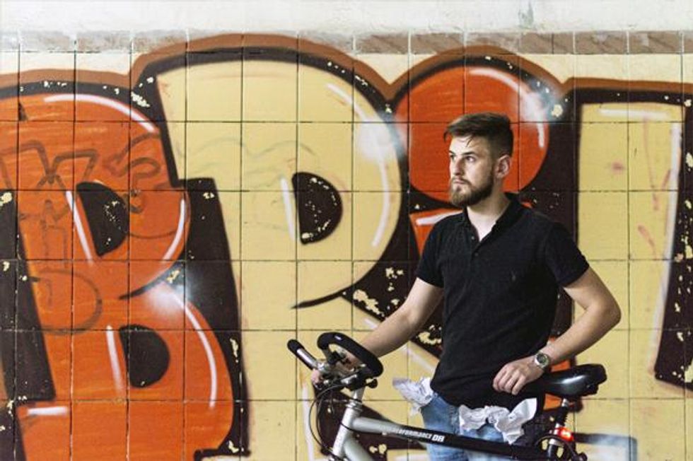 Taras D on bike in subway with graffiti
