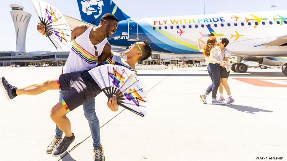 Teraj and Barry dip in front of Alaska Airlines Pride plane