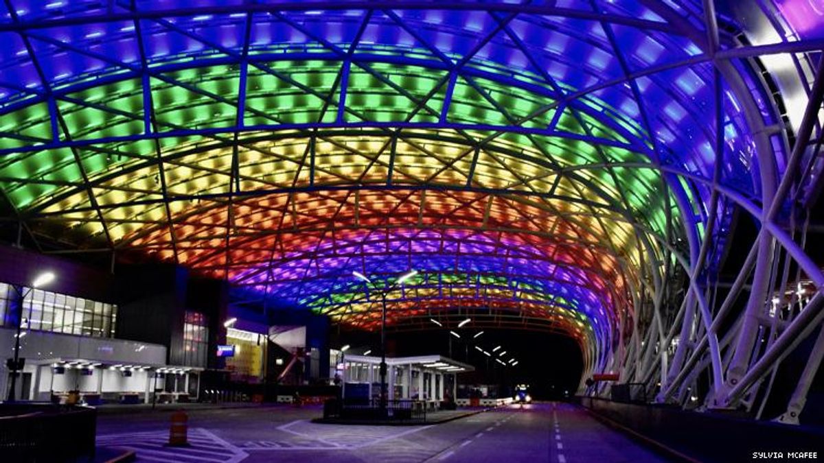 The Atlanta airport at night lit up in rainbow colors to celebrate 50 years of LGBTQ Pride