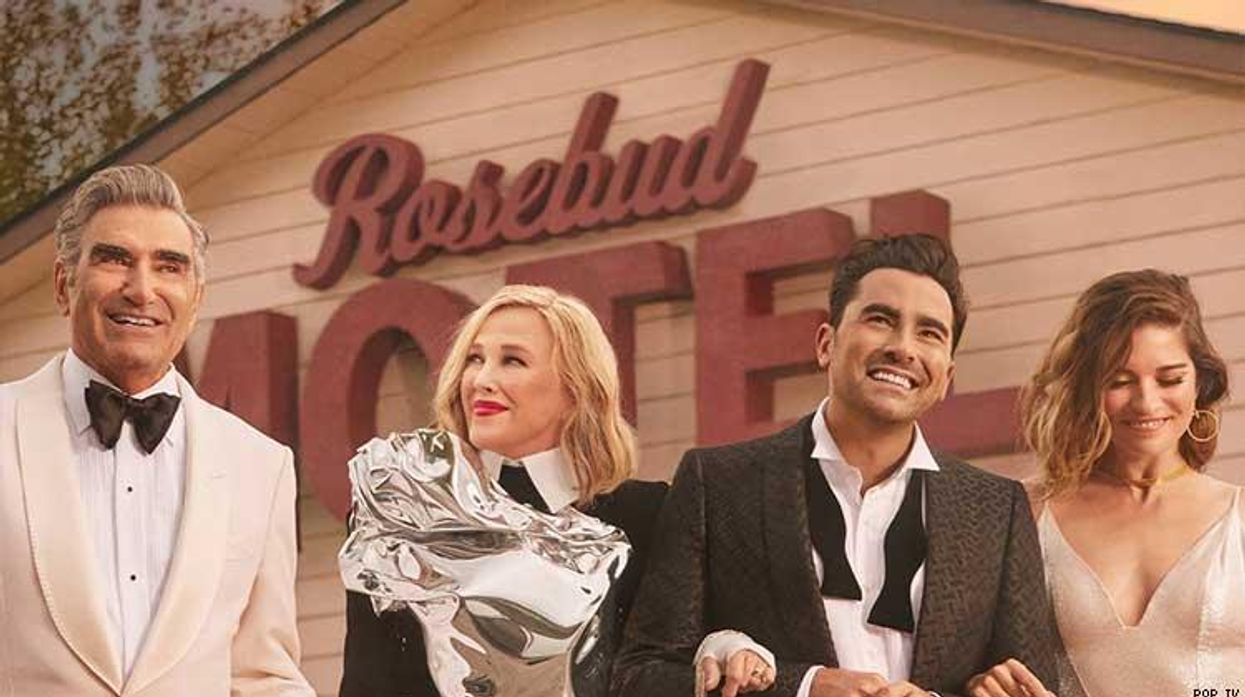 The cast of Schitt's Creek in front of the Rosebud Motel