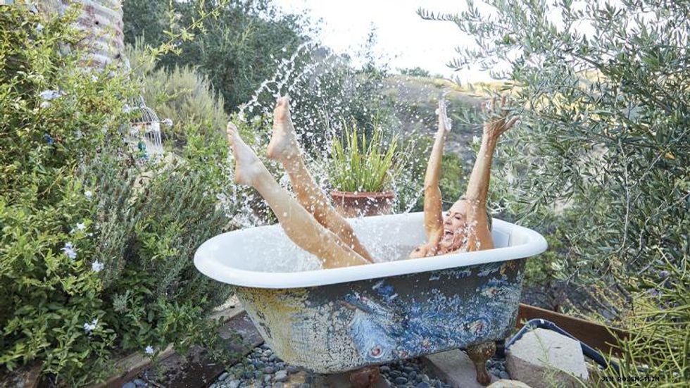 The Real Housewives of Orange County Braunwyn Windham-Burke naked in a tub in Out Traveler magazine